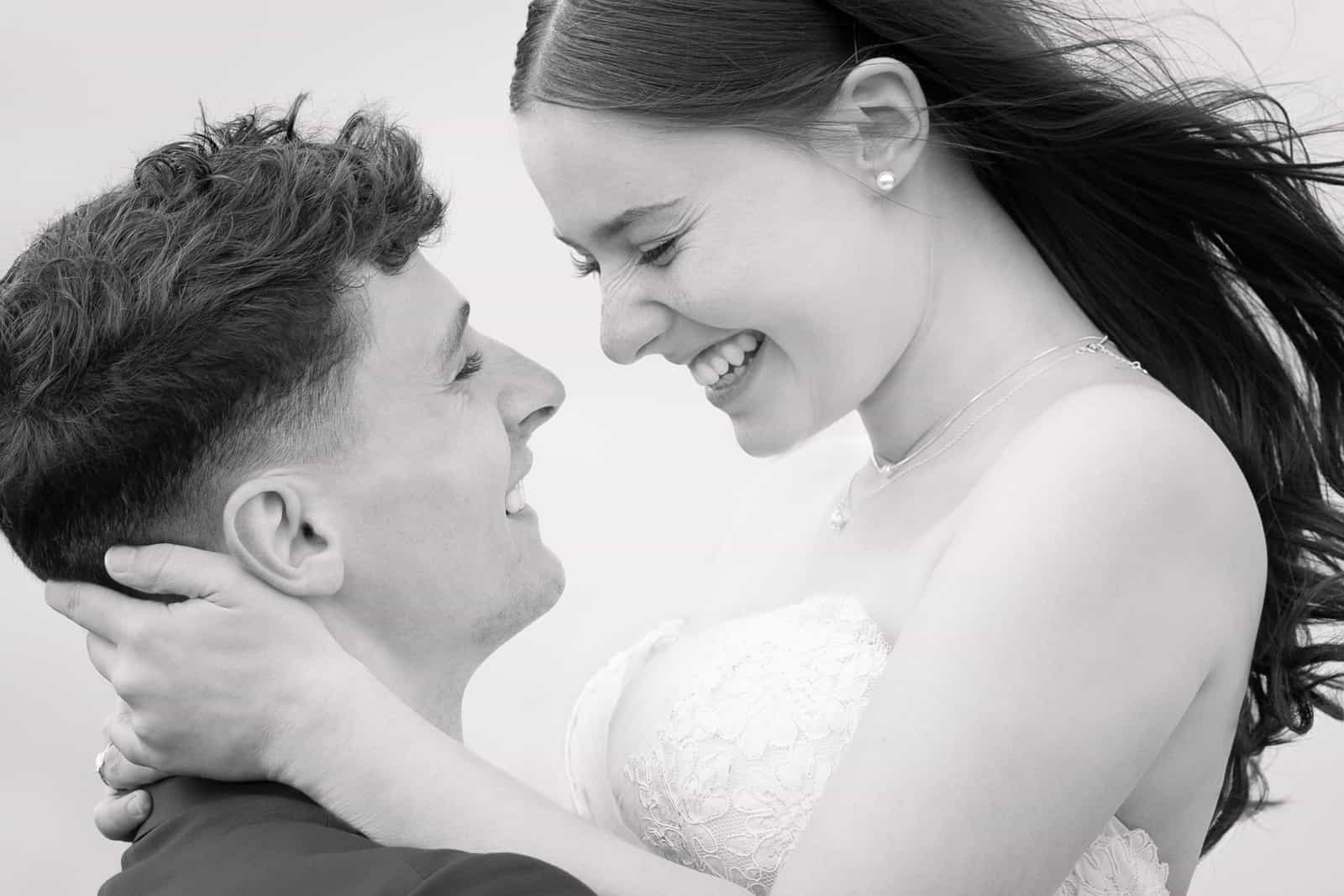 Bride and groom in intimate embrace, black and white wedding photo, documentary wedding photography