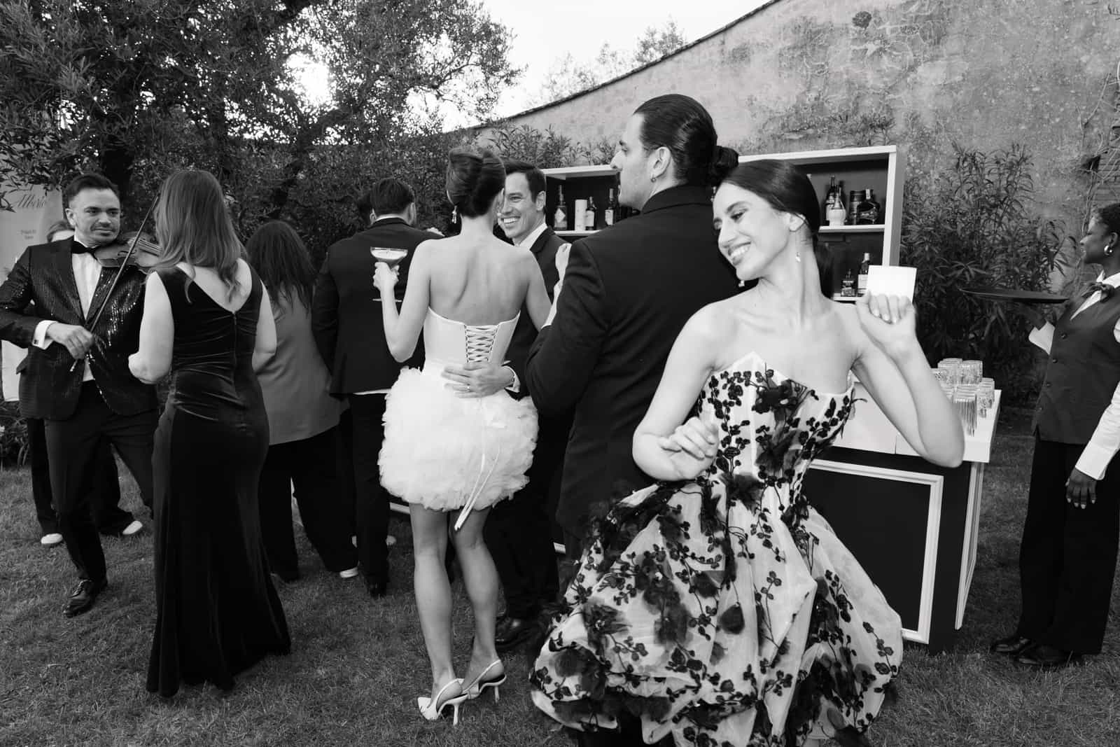Wedding guests dancing joyfully at the outdoor garden party